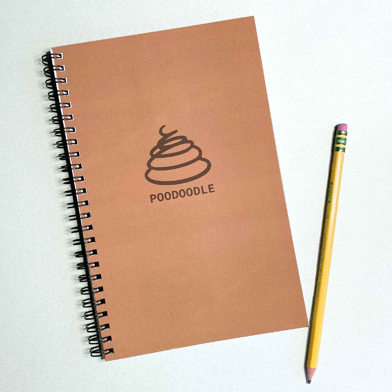 Brown journal with poop emoji and the title poodoodle